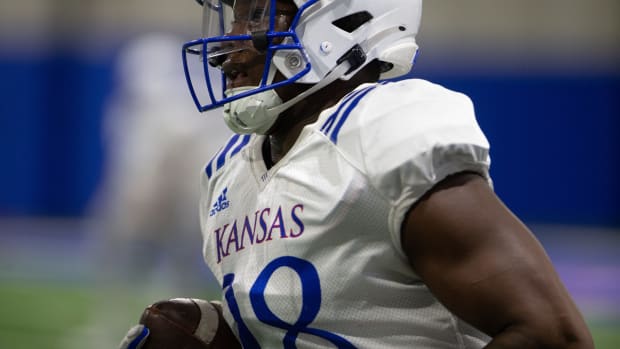Kansas junior linebacker JB Brown (28) runs a play during Thursday's practice.  